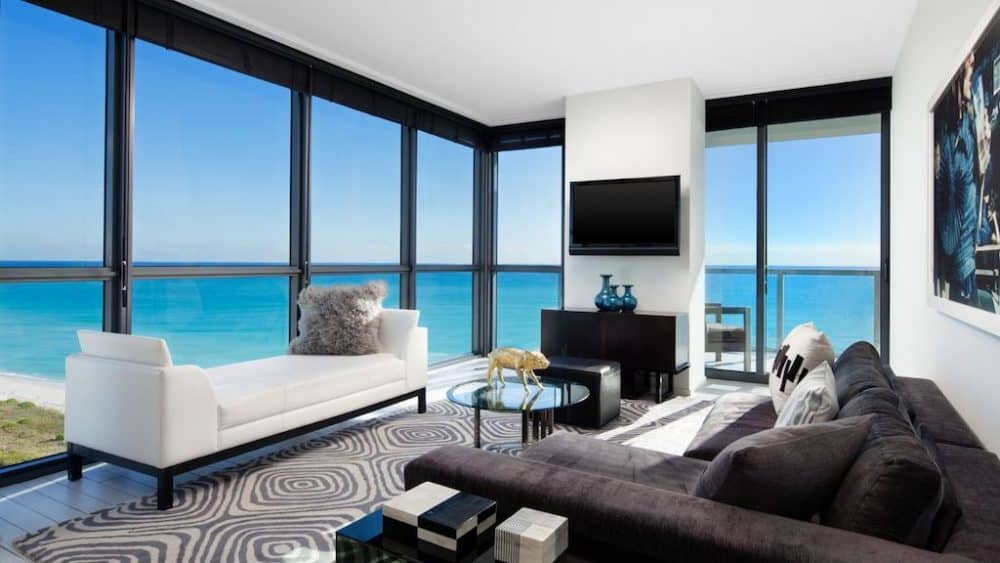 A living room filled with furniture and a large window in W South Beach Hotel 