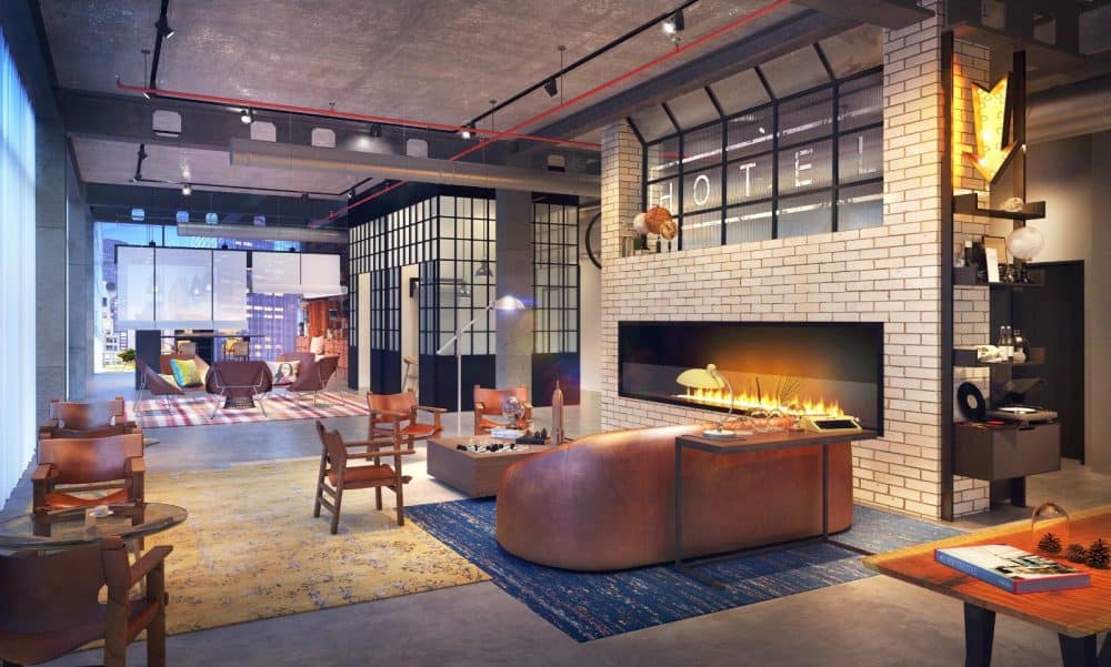 A living room filled with furniture and a fire place at Moxy Hotel In The New Orleans