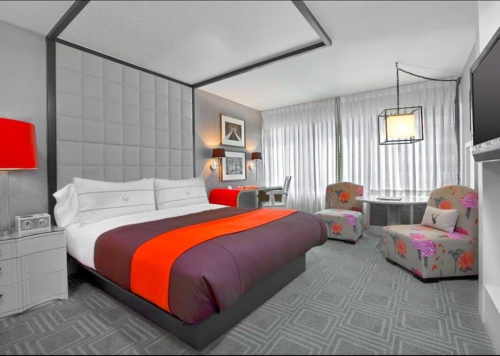 A bedroom with a bed and desk in a room W Hotel Buckhead in Atlanta